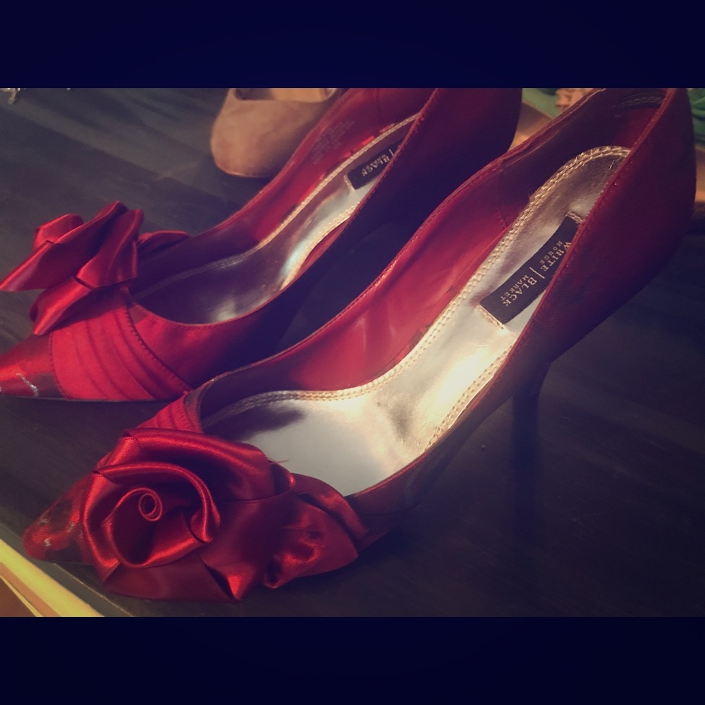 Red satin pumps with decorative rose.